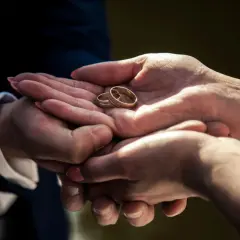 Dwie dłonie trzymają złote obrączki. Zastanawiasz się, ile waży obrączka?